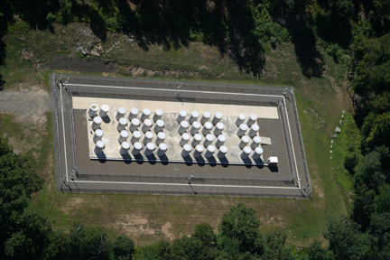 Aerial view of an ISFSI, showing the array of reinforced concrete storage casks in their fenced enclosure