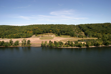 View across the Sherman Reservoir from Yankee Rowe showing trees and shrubland on the river shore